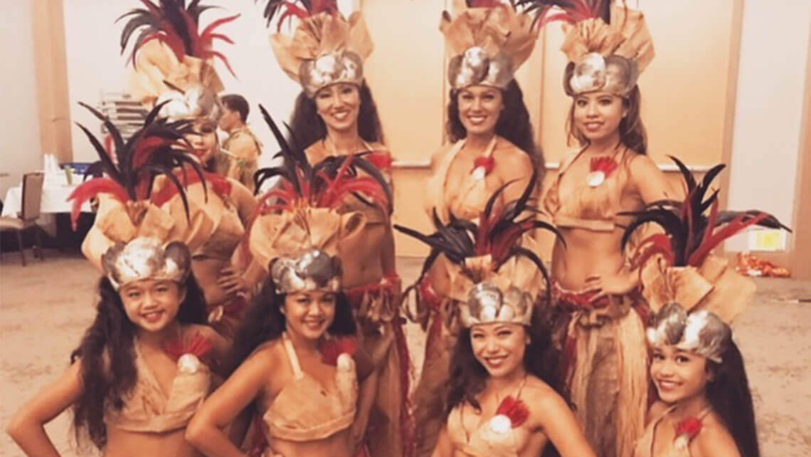 group of hula dancers in costumes