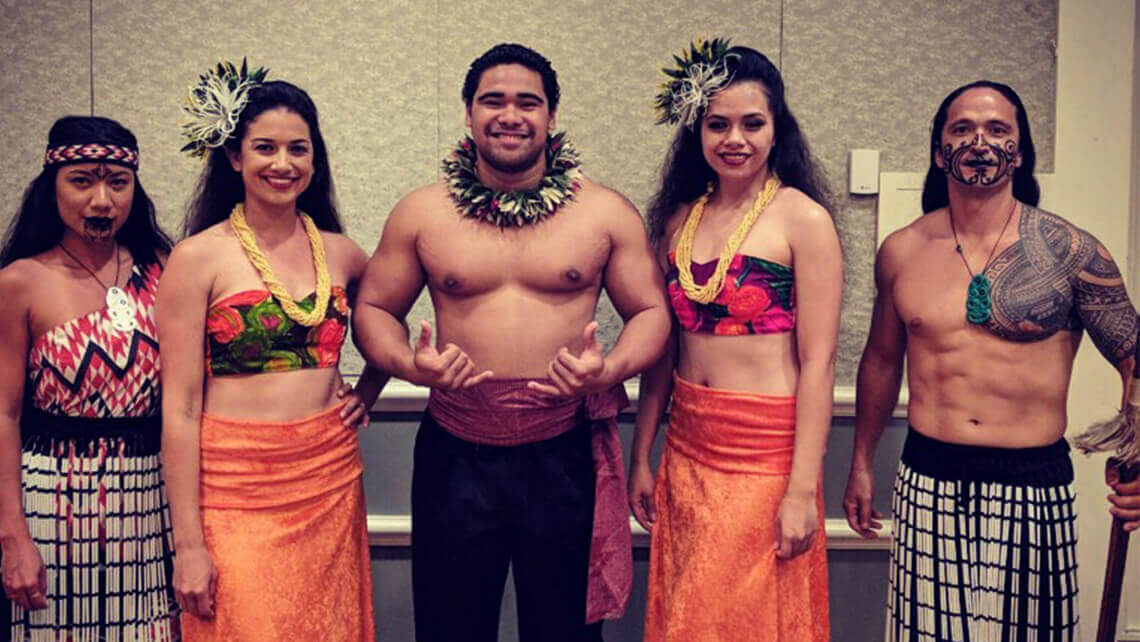 group of hula dancers in costumes