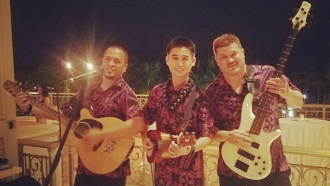 hawaiian musicians in matching aloha shirt