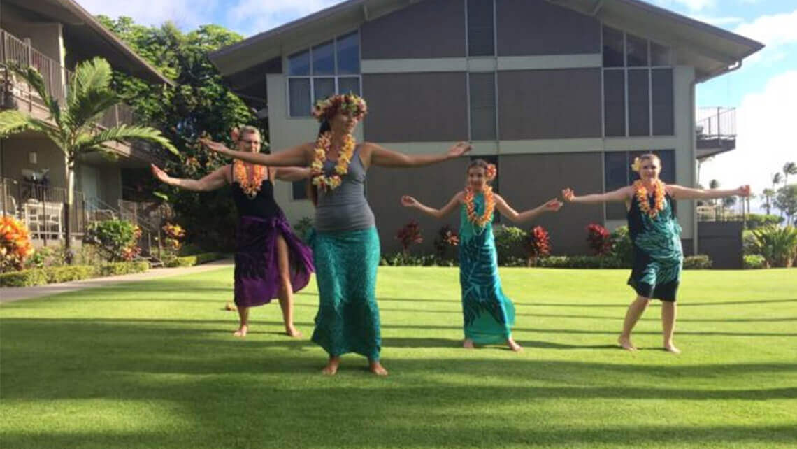 family learning on to hula dance